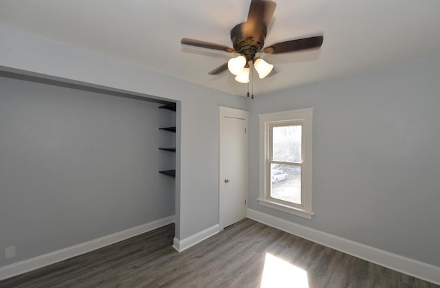 unfurnished bedroom featuring dark wood-type flooring and ceiling fan