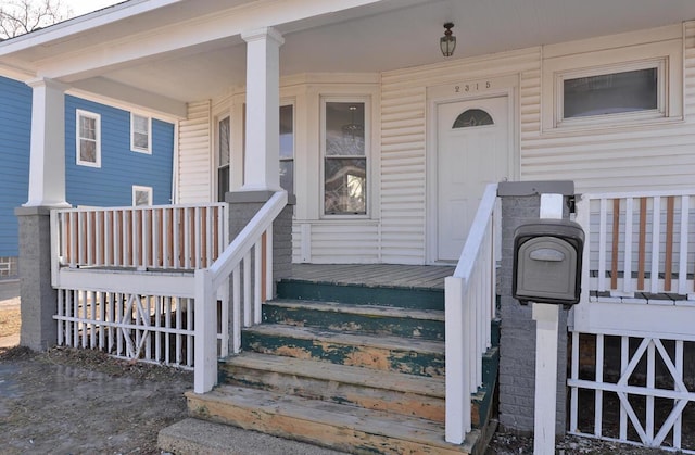 view of exterior entry with a porch