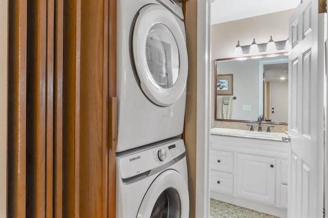 washroom with stacked washer / dryer and sink