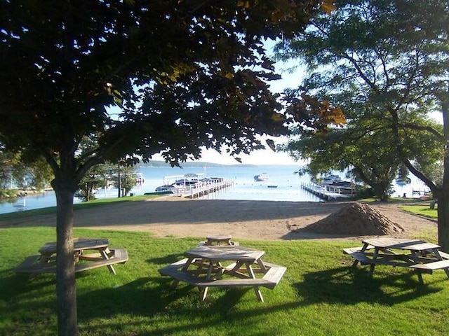 surrounding community featuring a water view and a yard