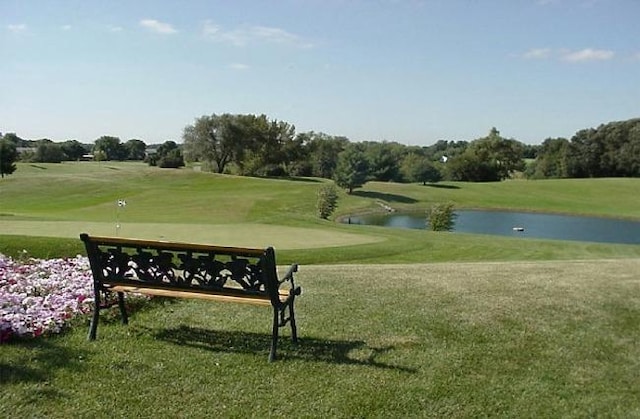 surrounding community featuring a water view and a yard