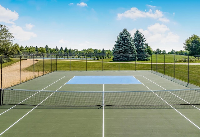 view of sport court with a yard