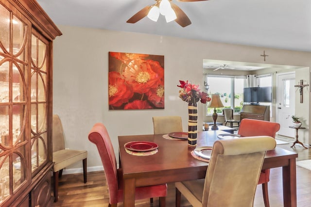 dining space with hardwood / wood-style floors and ceiling fan