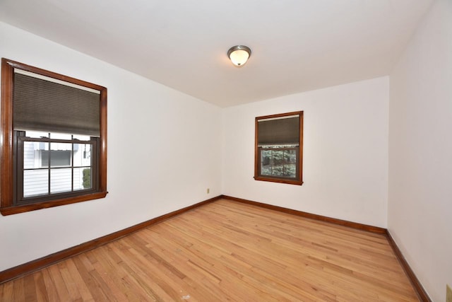 spare room with light hardwood / wood-style flooring