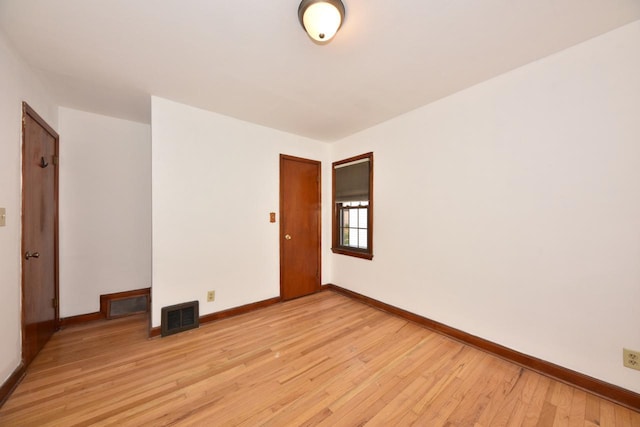 empty room with light hardwood / wood-style floors