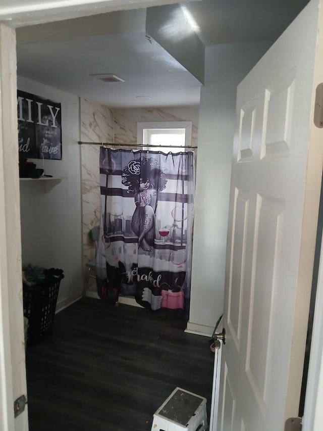 bathroom featuring hardwood / wood-style floors and a shower with curtain