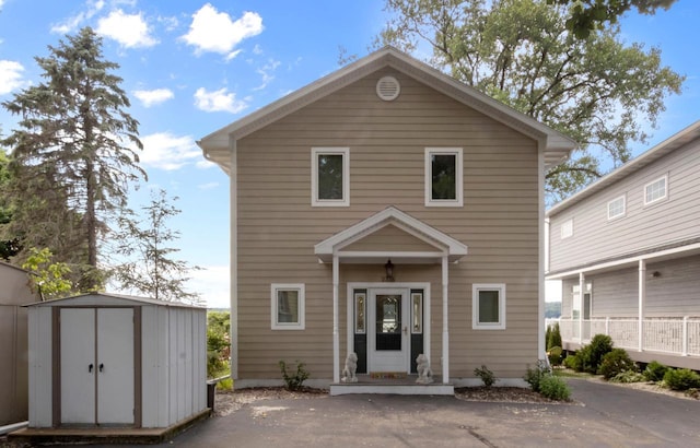 view of front property with a shed