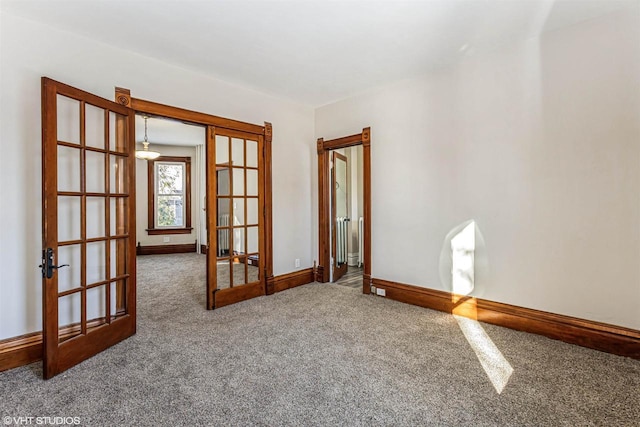 empty room with french doors and carpet floors