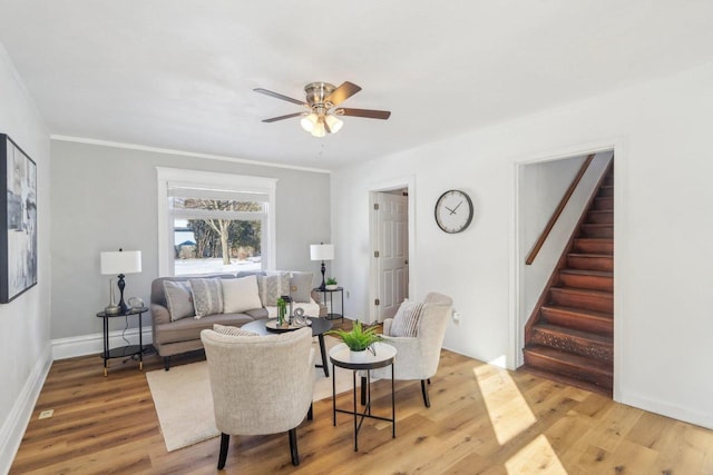 living room with ceiling fan, stairway, wood finished floors, and baseboards