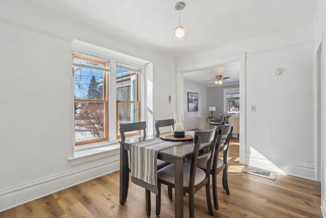 dining space with visible vents and wood finished floors