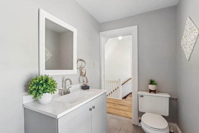 bathroom with vanity, toilet, and tile patterned floors