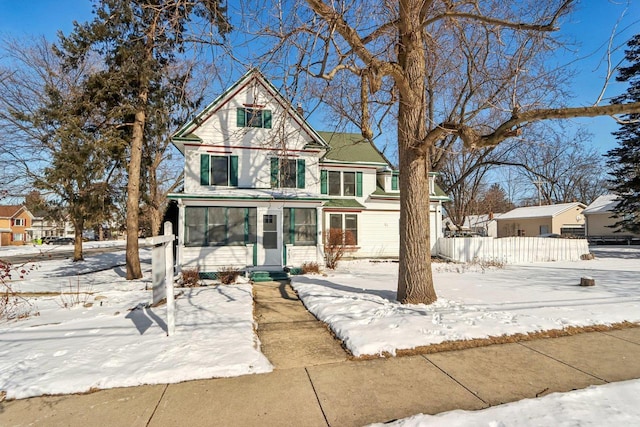 victorian-style house featuring entry steps and fence