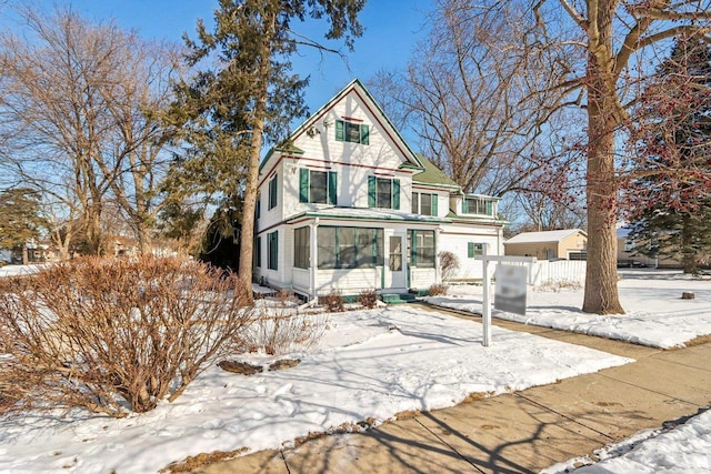 victorian-style house with fence