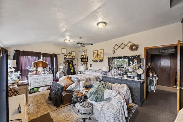 bedroom with lofted ceiling, ceiling fan, and carpet flooring