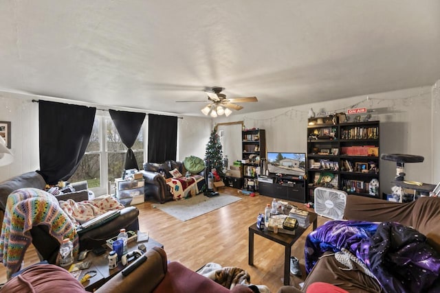 living room with hardwood / wood-style flooring and ceiling fan