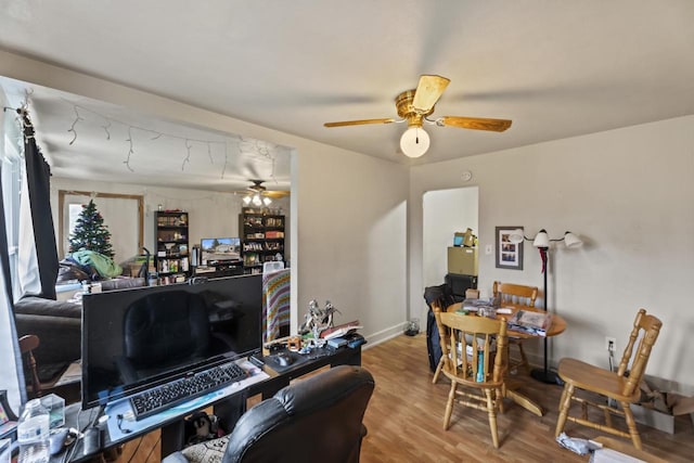 home office with hardwood / wood-style floors and ceiling fan