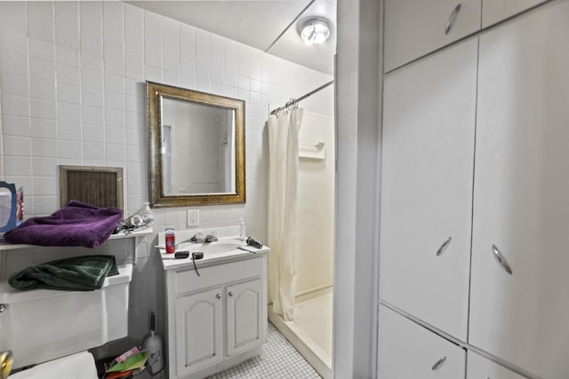 bathroom with toilet, curtained shower, and tile walls