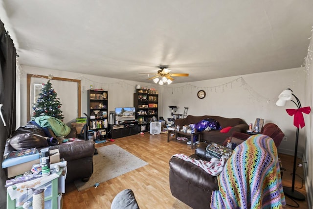 living room featuring hardwood / wood-style floors and ceiling fan