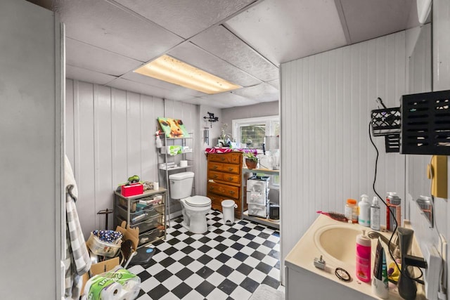 bathroom featuring vanity, a drop ceiling, and toilet