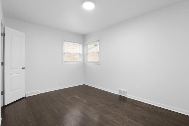 spare room with dark wood-type flooring