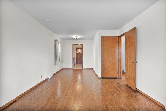 foyer entrance with baseboards and wood finished floors