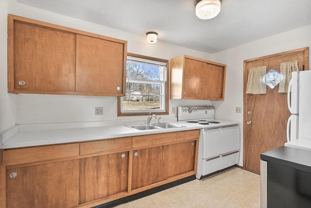 kitchen featuring white appliances, light floors, a sink, light countertops, and brown cabinets