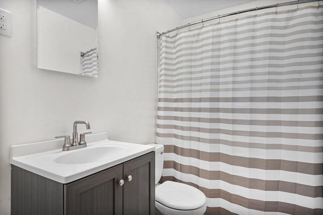 bathroom featuring vanity, a shower with shower curtain, and toilet