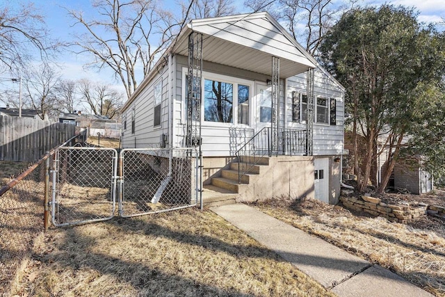 view of front of house featuring fence and a gate