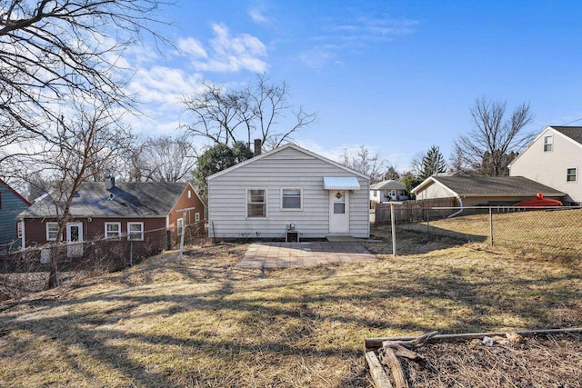 back of property with a yard and a fenced backyard