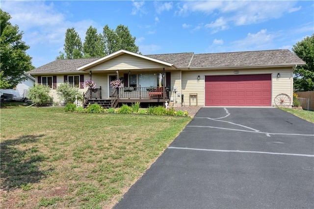 single story home with a garage, a front lawn, and a porch