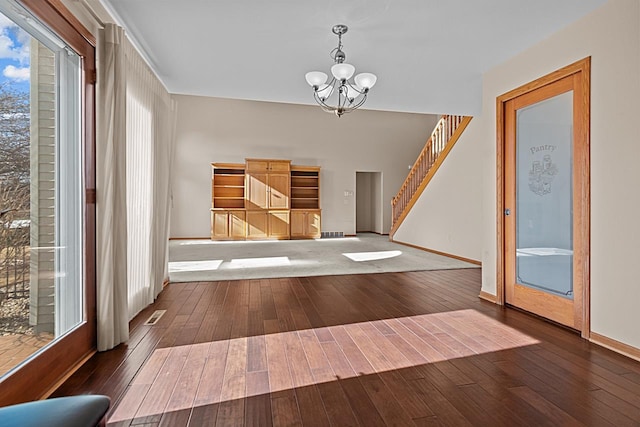 foyer featuring dark hardwood / wood-style floors and a chandelier