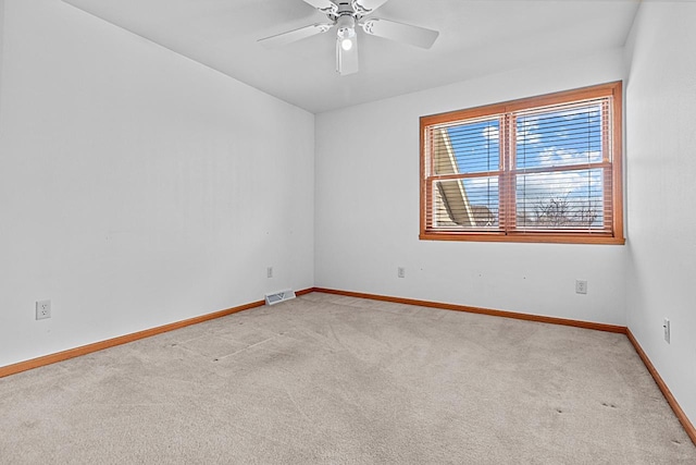 carpeted spare room with ceiling fan