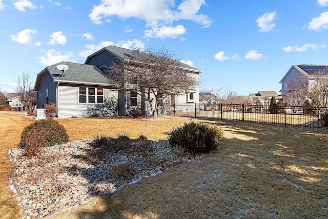 rear view of house with a yard and central air condition unit