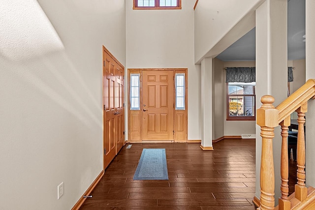 entrance foyer featuring dark wood-type flooring and a high ceiling