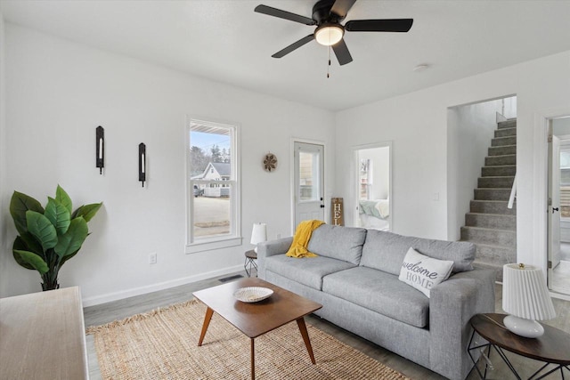 living room featuring ceiling fan and wood-type flooring