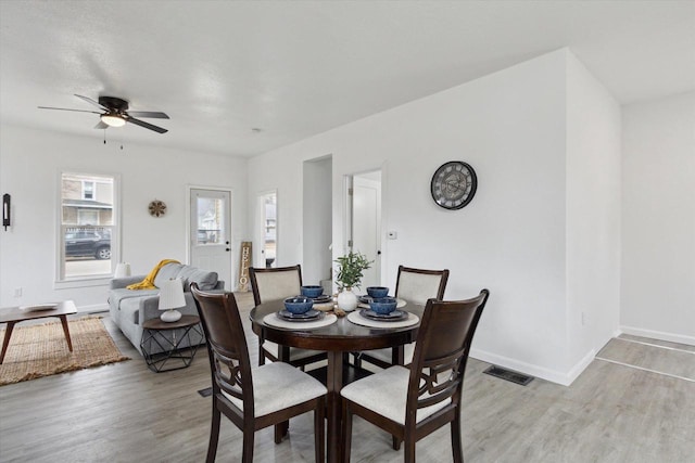 dining area featuring ceiling fan and light wood-type flooring