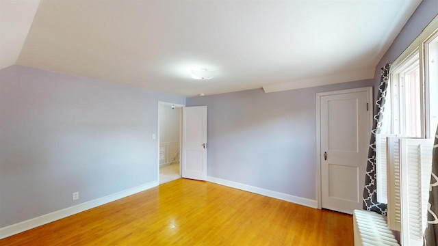 unfurnished room with hardwood / wood-style floors