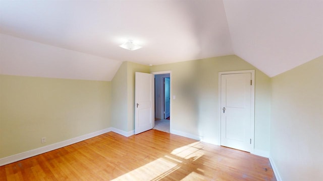 additional living space featuring lofted ceiling and wood-type flooring