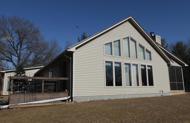 W5698 Losinski Rd, Princeton, WI 54968 - view of side of home featuring a sunroom and a chimney