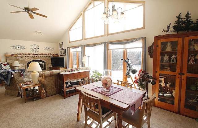 W5698 Losinski Rd, Princeton, WI 54968 - dining space featuring light carpet, high vaulted ceiling, a chandelier, a brick fireplace, and ceiling fan