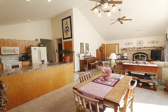 W5698 Losinski Rd, Princeton, WI 54968 - dining room featuring light carpet, high vaulted ceiling, a ceiling fan, a brick fireplace, and recessed lighting
