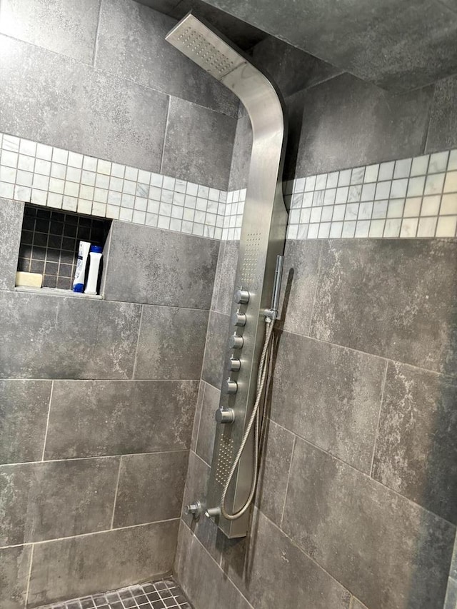 bathroom with a tile shower