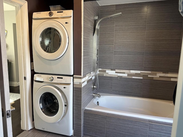 clothes washing area featuring stacked washer / drying machine