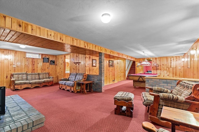 living room featuring carpet floors and wood walls