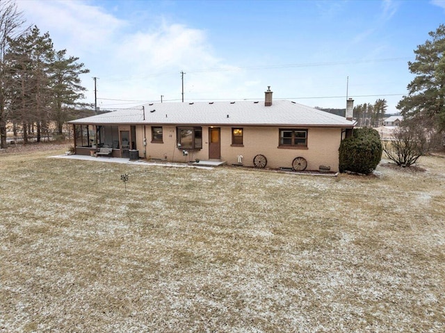 back of property featuring a lawn and a patio area