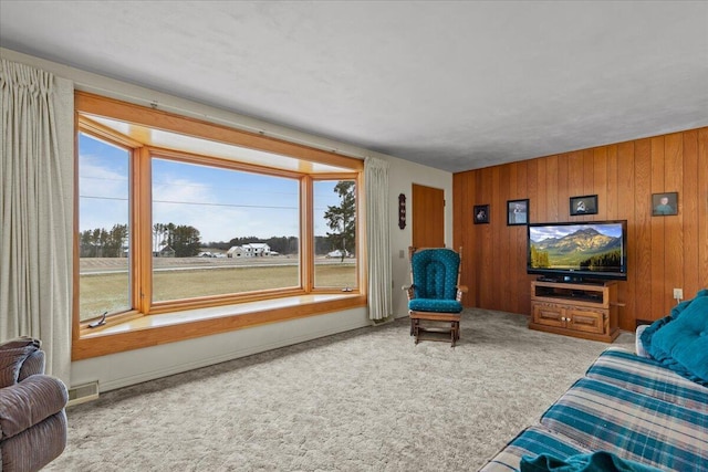 living room with wood walls and carpet flooring