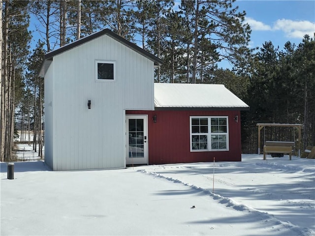 view of snow covered back of property