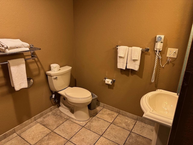 bathroom with tile patterned flooring, sink, and toilet