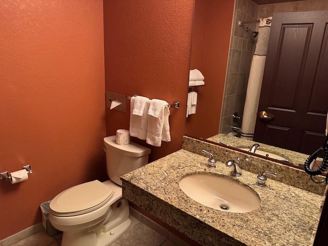 bathroom with tile patterned flooring, sink, and toilet