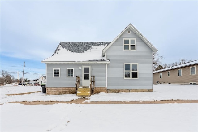 view of snow covered rear of property